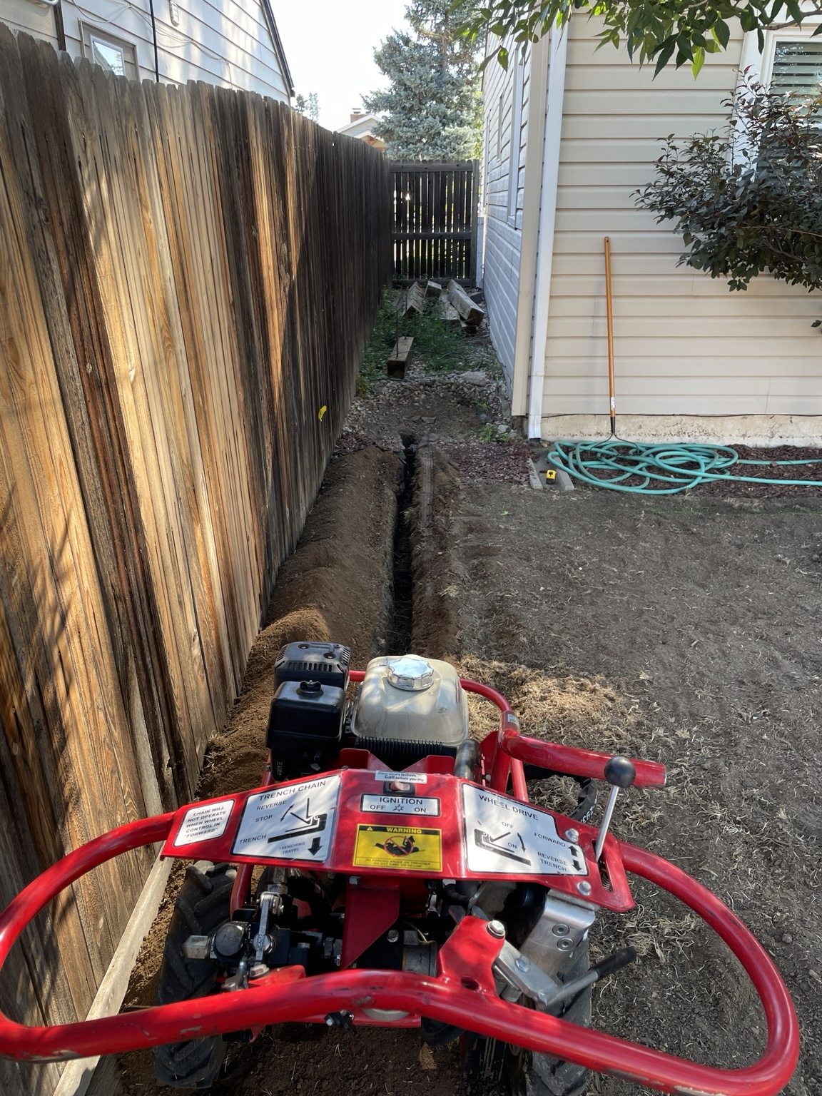 A narrow irrigation trench cut beside a trencher