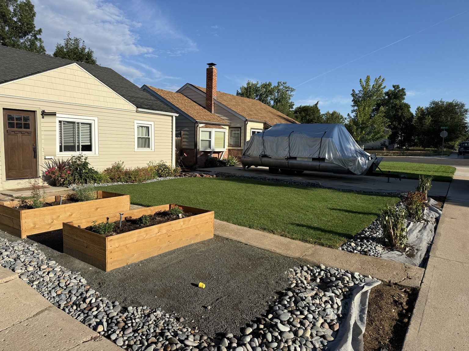 Front yard after the raised beds and gravel were in place, with the lawn still filling in