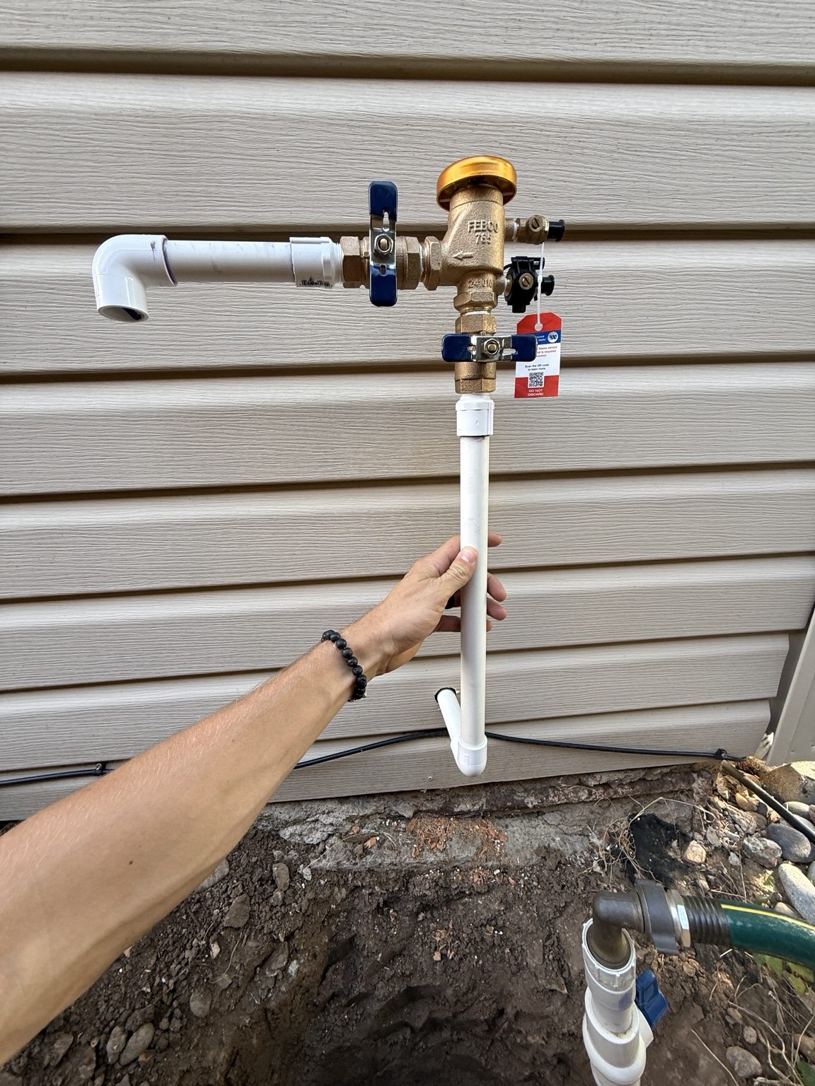 Irrigation supply valves and piping assembled at an exterior wall