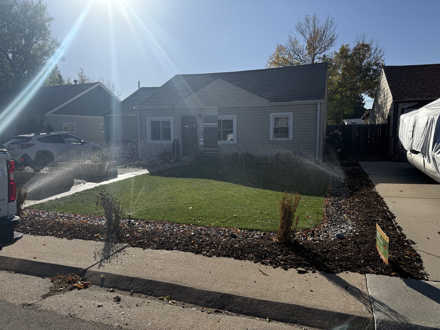 Finished front yard with raised beds, gravel, and irrigation running